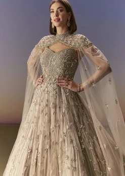 Beige Gown With Shoulder Cape And Rich Vertical Embroidery