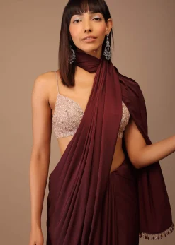 Blood Red Satin Saree With Fringes On The Pallu Paired With Hand Embroidered Bustier