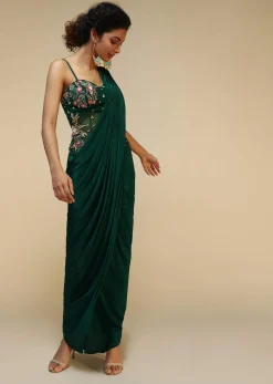 Bottle Green Saree Gown With A Crepe Cowl Drape And Sheer Embroidered Net Bodice With Colorful Resham Flowers