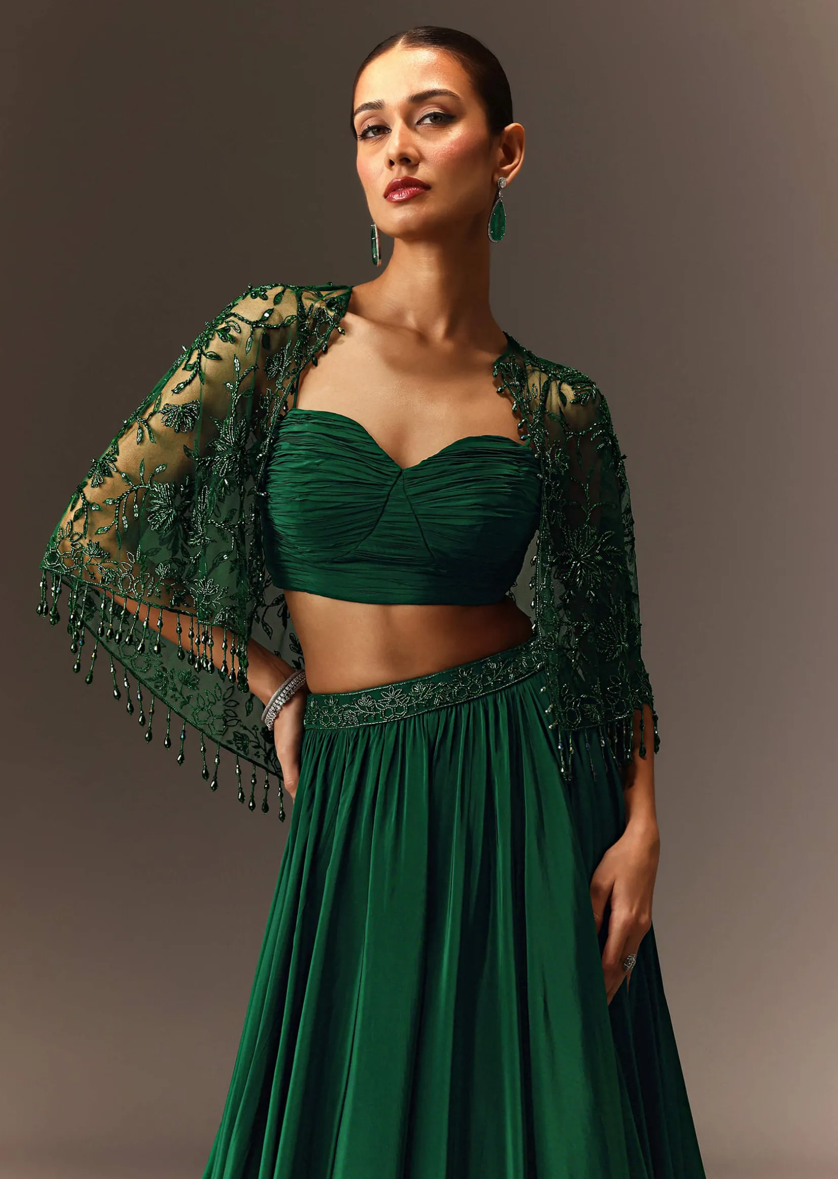 Bottle Green Tiered Lehenga With Net Cape
