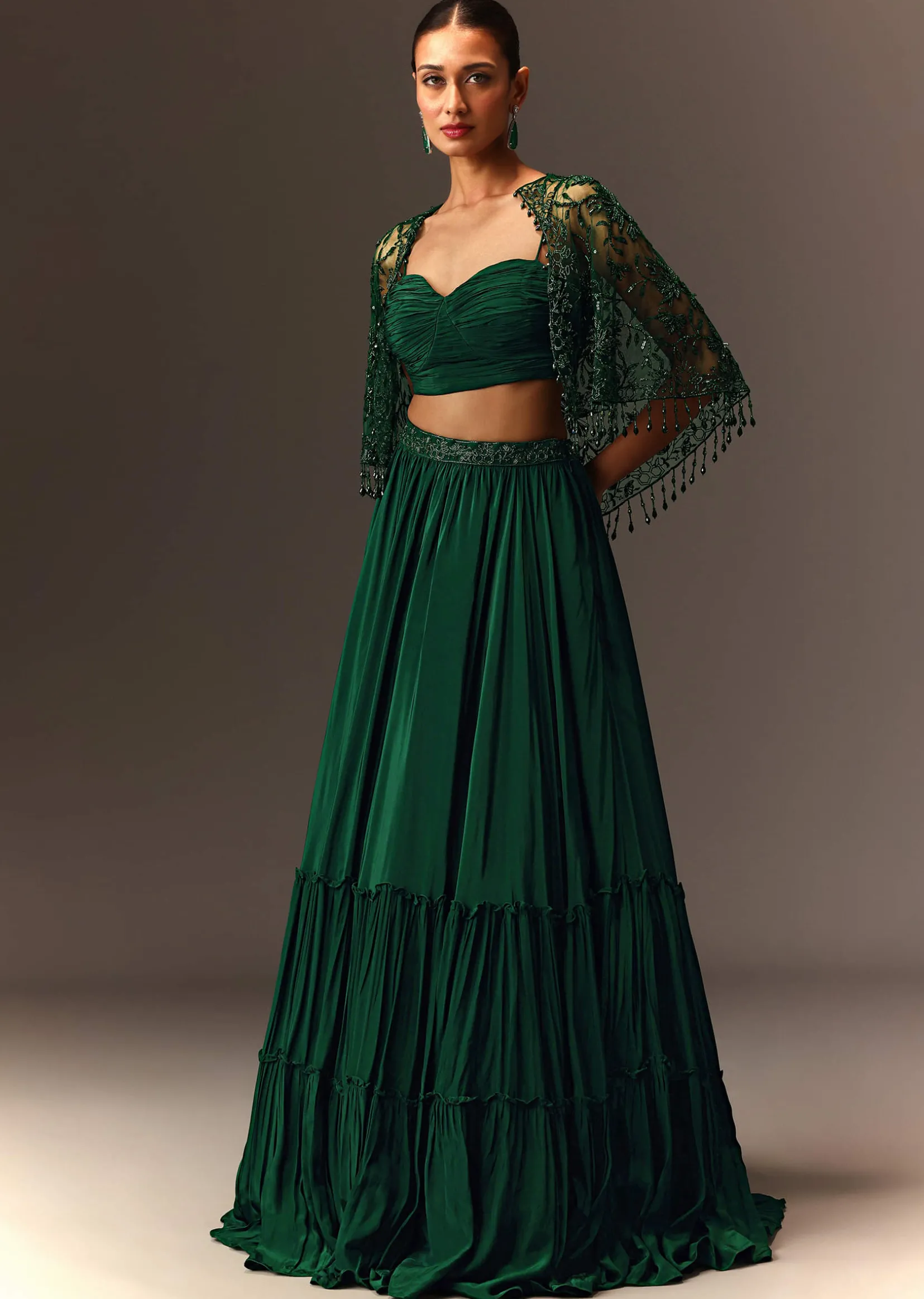 Bottle Green Tiered Lehenga With Net Cape
