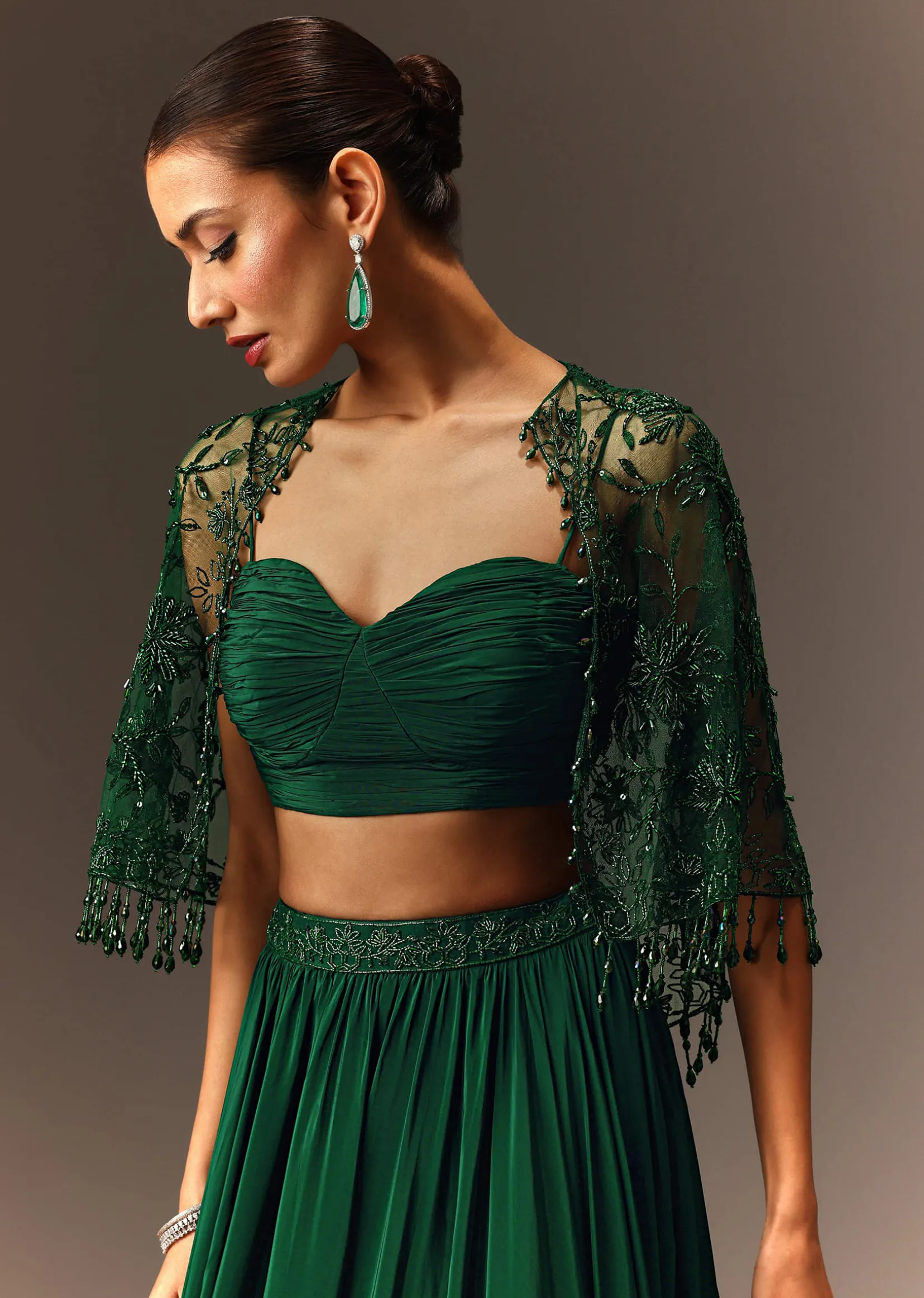 Bottle Green Tiered Lehenga With Net Cape