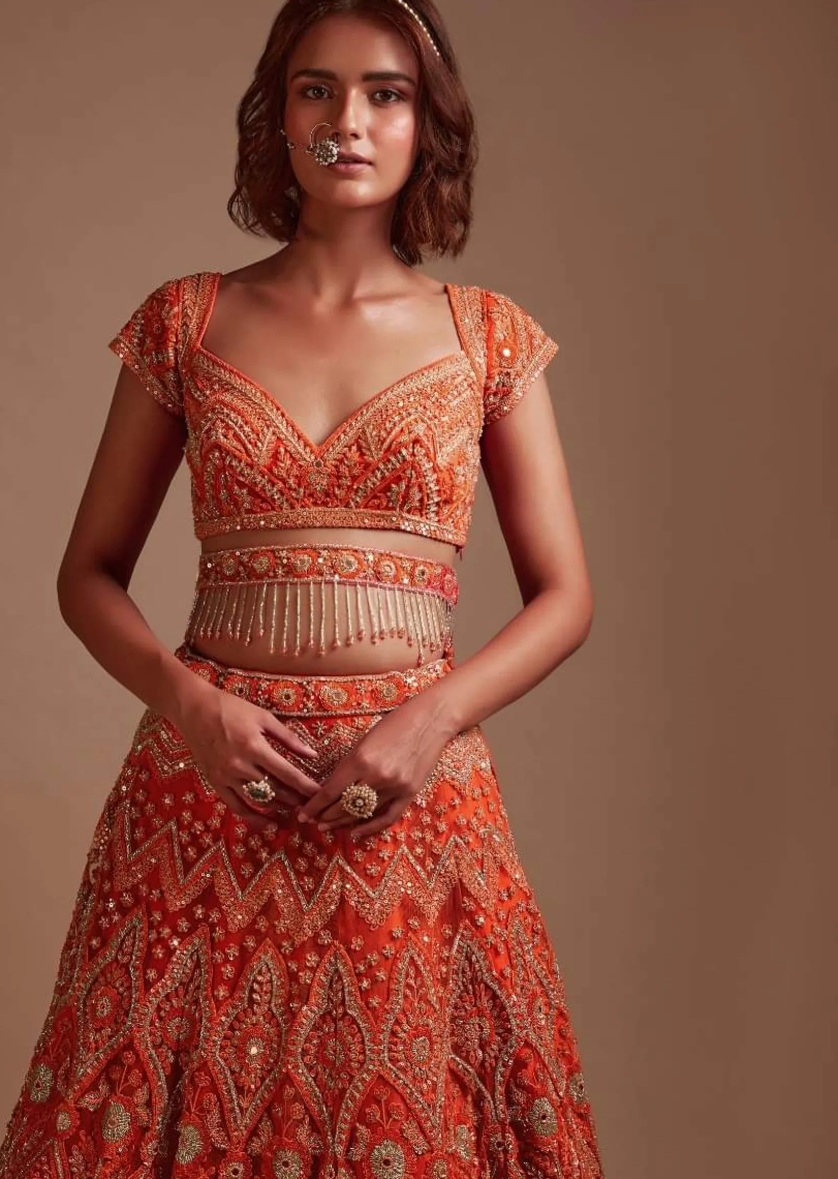 Coral Orange Lehenga Choli In Net With Mirror And Sequins Embroidered Floral And Mughal Embroidery Along With Belt Detailing