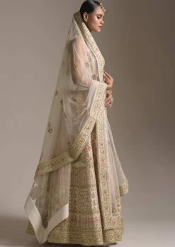 Creamy Pink Lehenga Choli In Raw Silk With Pink Resham And Zardosi Embroidered Floral Kalis Online - Kalki Fashion