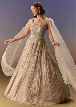 Gold Gown With Pleated Panels And Dramatic Cape