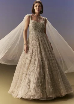 Gold Gown With Pleated Panels And Dramatic Cape