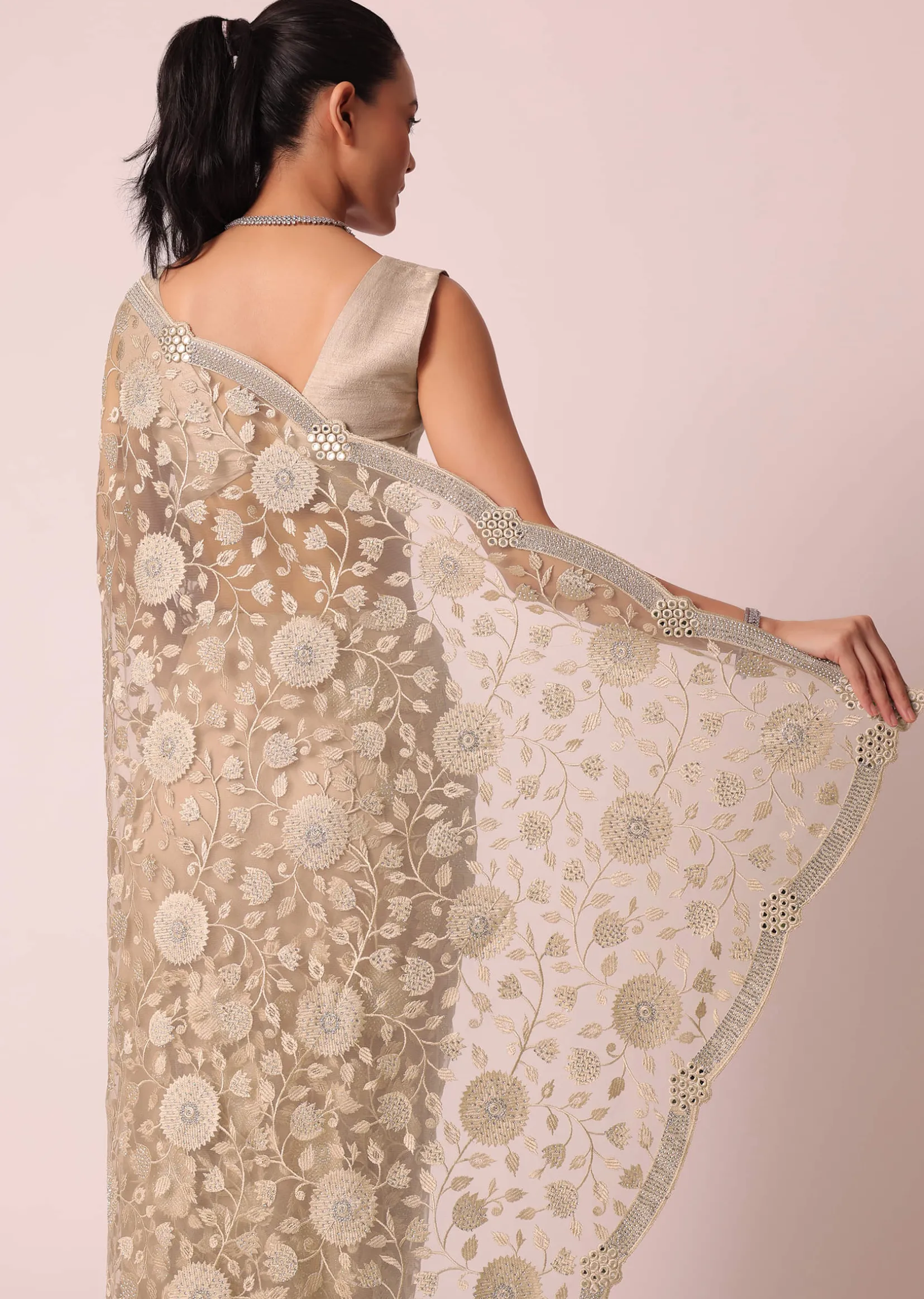 Gold Net Saree With Stone Studded And Floral work And Unstitched Blouse Piece