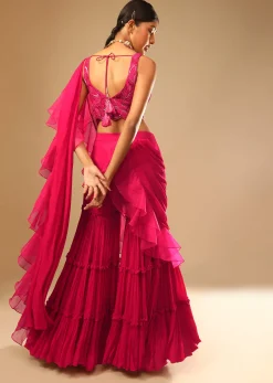 Hot Pink Crop Top Sharara Suit With An Attached Ruffle Draped And An Hand Embroidered Leaf Motifs