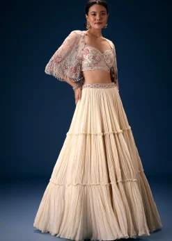 Off White Tiered Lehenga With Embroidered Corset Blouse And Embroidered Cape