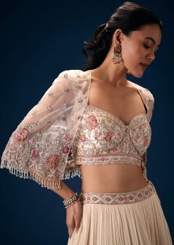 Off White Tiered Lehenga With Embroidered Corset Blouse And Embroidered Cape