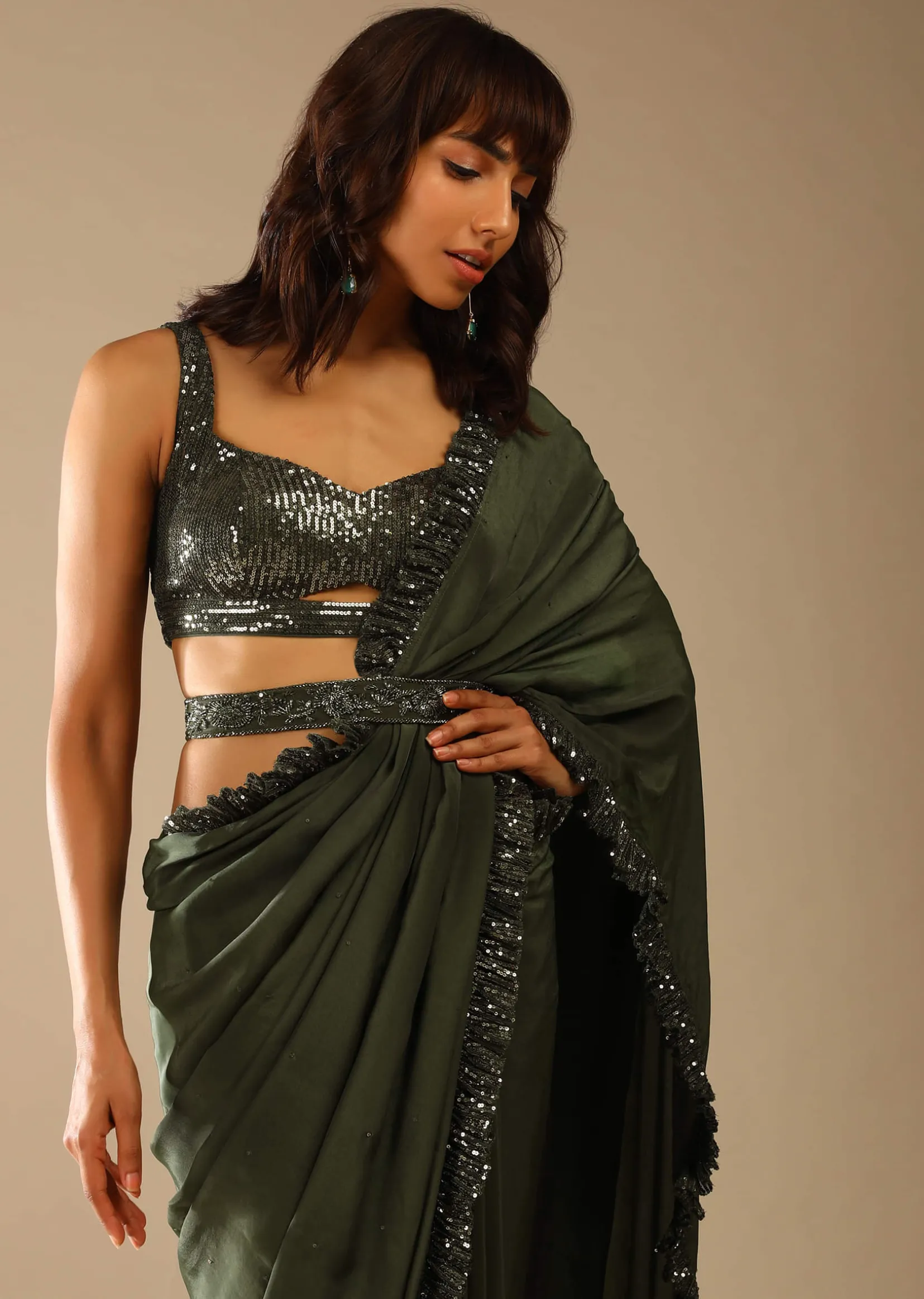 Olive Green Saree In Crepe With Sequins Ruffle On The Border, Sequins Blouse With Front Cut Out And Embellished Belt