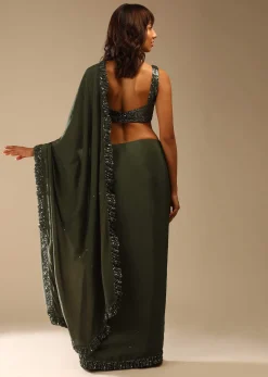 Olive Green Saree In Crepe With Sequins Ruffle On The Border, Sequins Blouse With Front Cut Out And Embellished Belt