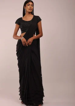 Pitch Black Saree With Three Tones Of Layered Frills On The Bottom Embellished In Stones And Sequins With A Tassel On The Pallu Corner