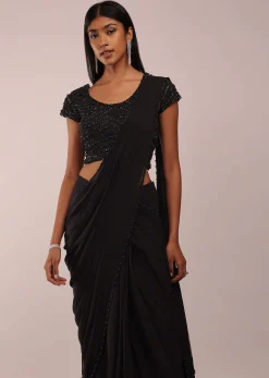 Pitch Black Saree With Three Tones Of Layered Frills On The Bottom Embellished In Stones And Sequins With A Tassel On The Pallu Corner