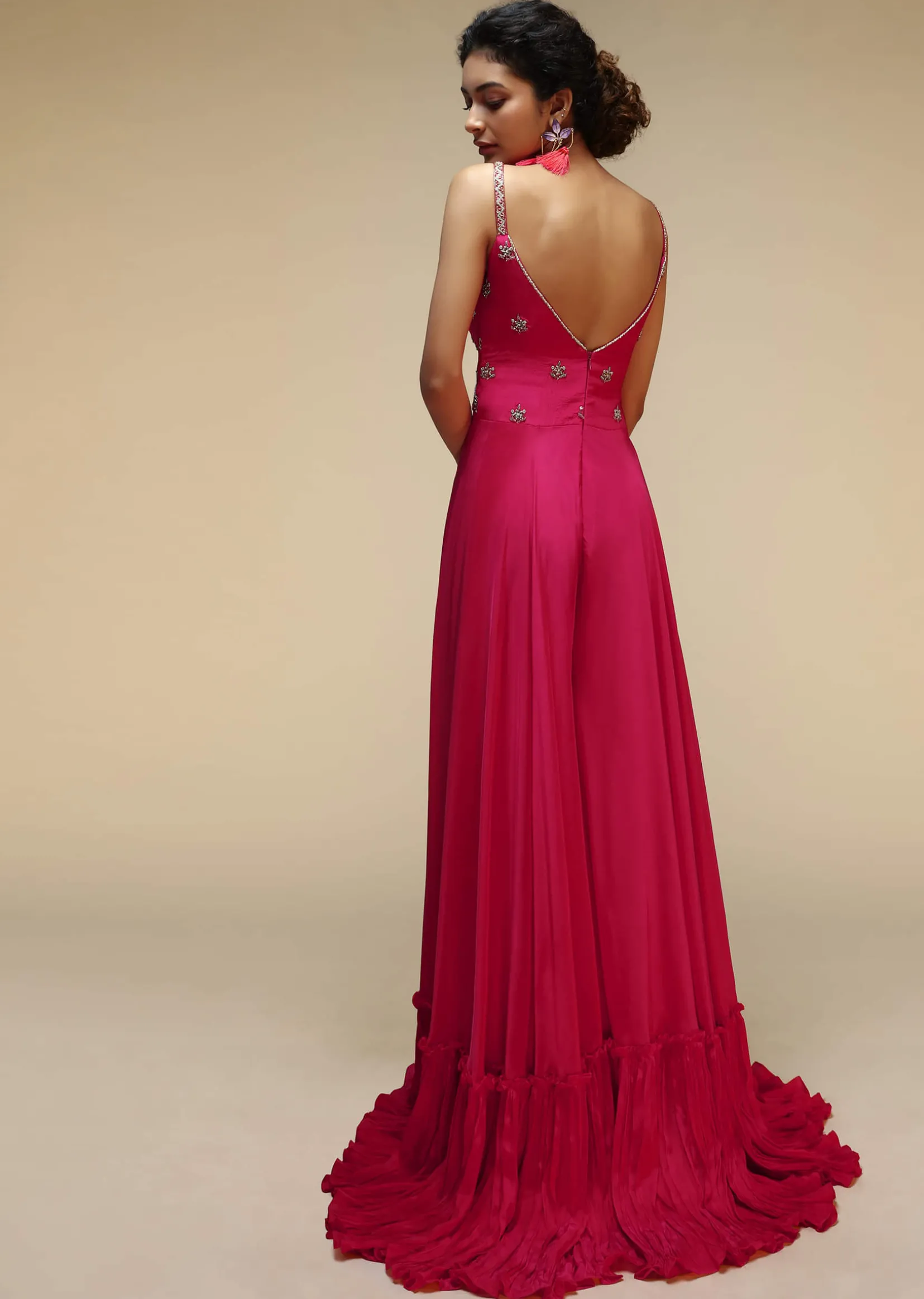 Rani Pink Jumpsuit With An Overlapping Neckline Adorned In Hand Embroidered Buttis Using Cut Dana And Sequins