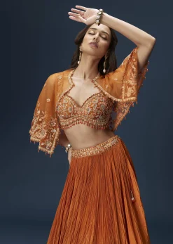 Rust Orange Embroidered Lehenga With Dramatic Cape And Blouse