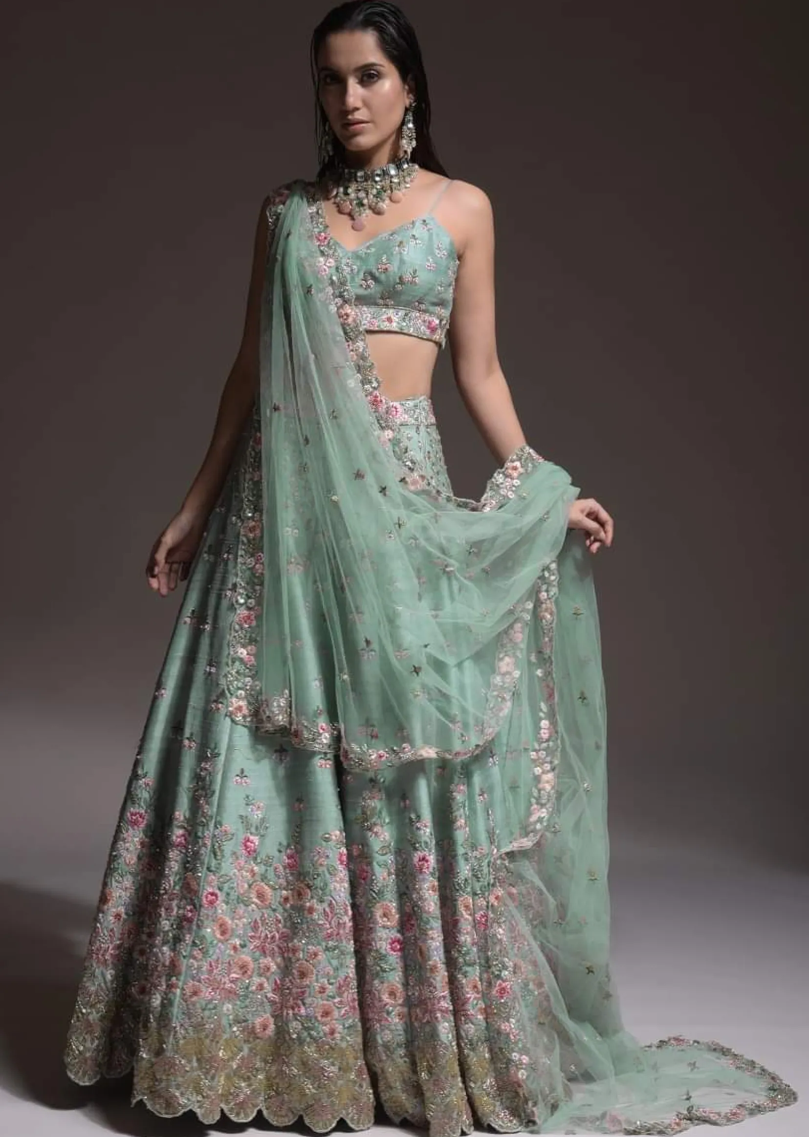 Sage Green Lehenga Choli In Raw Silk With Vibrant Resham Embroidered Cluster Of Summer Blooms And Buttis