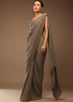 Taupe Grey Ready To Wear Saree With A Crop Top In Foil Applique Embellishment Sleeveless With A Tie-Up Tassel Dori At The Back.
