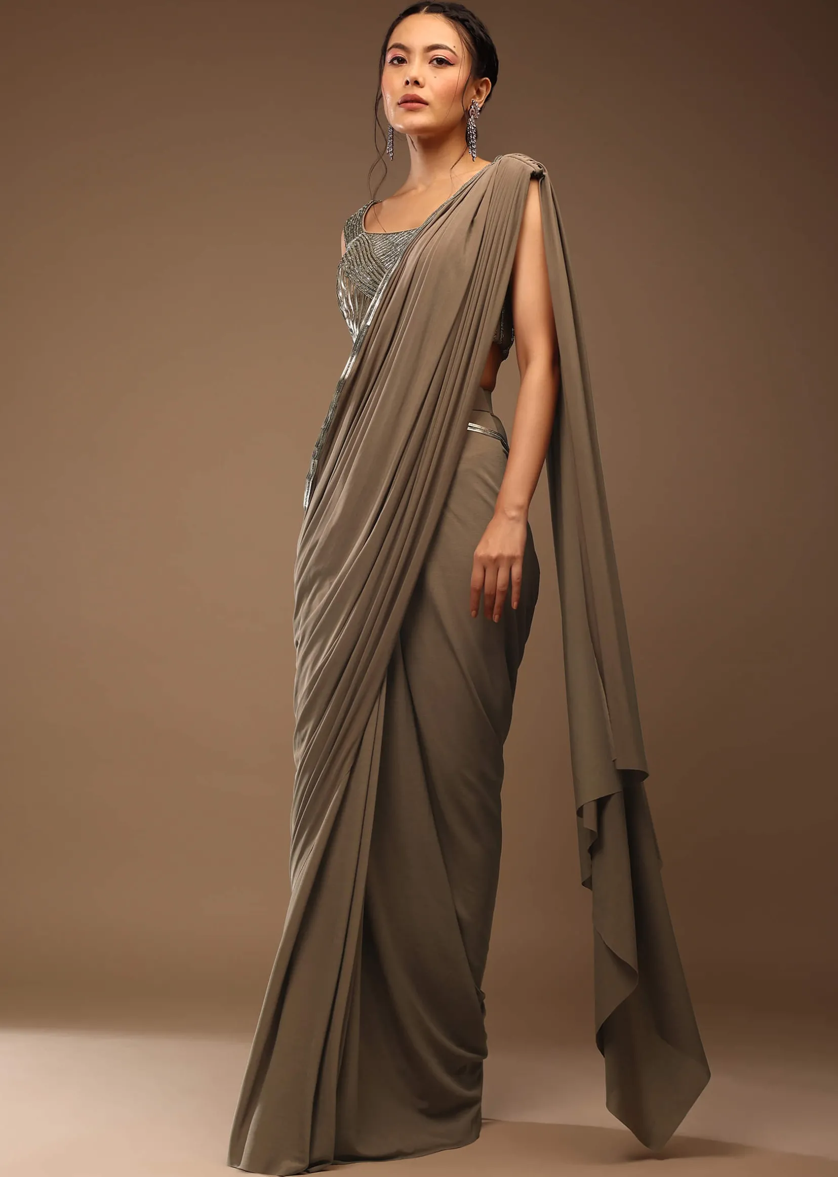 Taupe Grey Ready To Wear Saree With A Crop Top In Foil Applique Embellishment Sleeveless With A Tie-Up Tassel Dori At The Back.