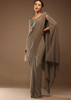 Taupe Grey Ready To Wear Saree With A Crop Top In Foil Applique Embellishment Sleeveless With A Tie-Up Tassel Dori At The Back.