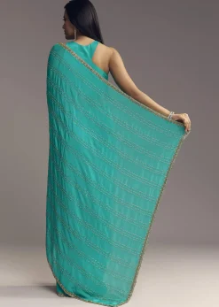 Turquoise Blue Embroidered Chinon Saree With Wavy Border