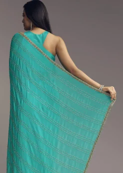 Turquoise Blue Embroidered Chinon Saree With Wavy Border