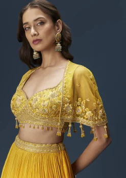 Yellow Bridesmaid Lehenga With Sleeveless Blouse And Draped Cape