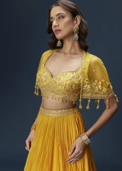 Yellow Bridesmaid Lehenga With Sleeveless Blouse And Draped Cape