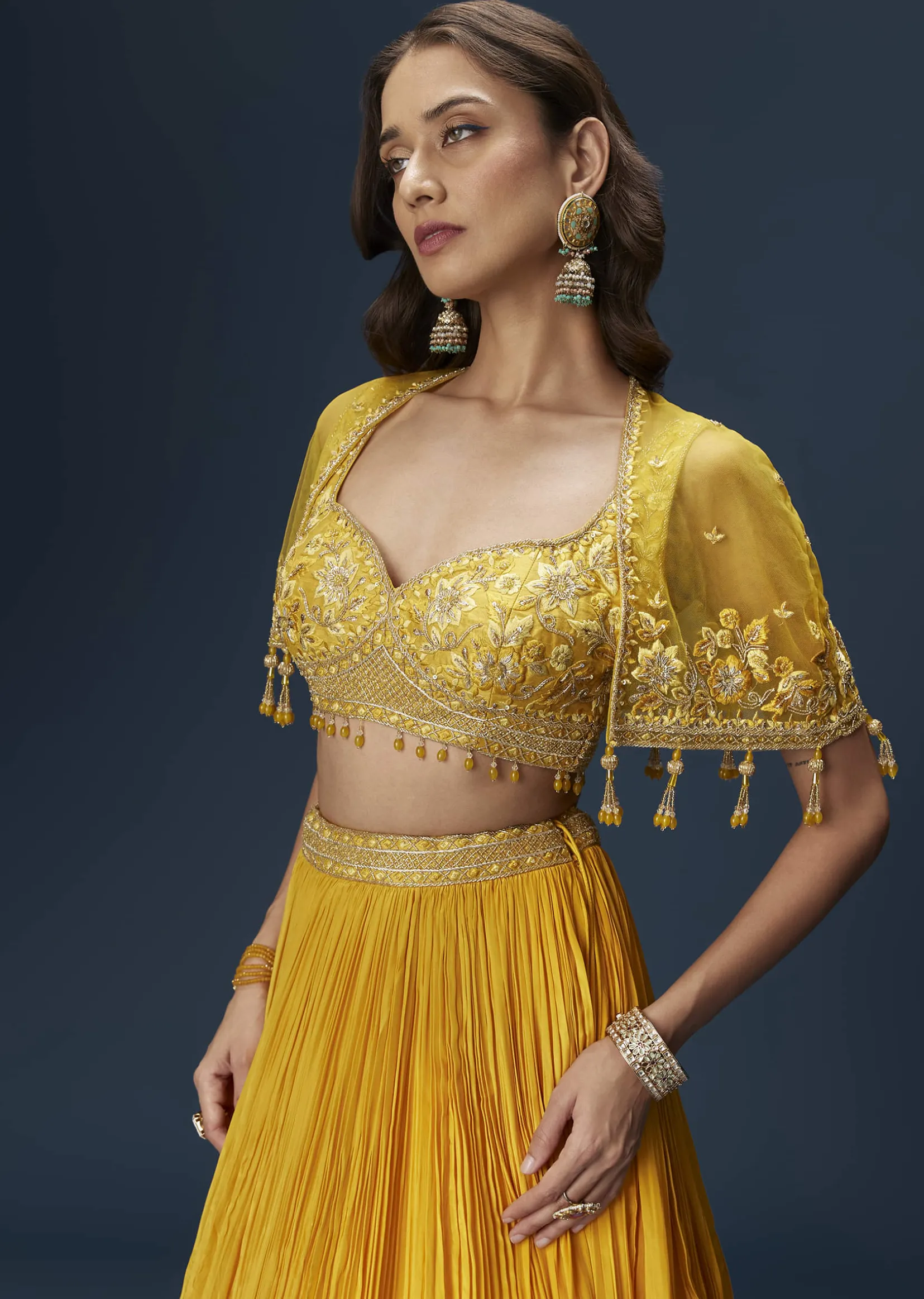 Yellow Bridesmaid Lehenga With Sleeveless Blouse And Draped Cape